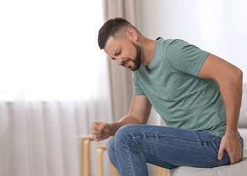 Difficulty sitting for long periods due to discomfort